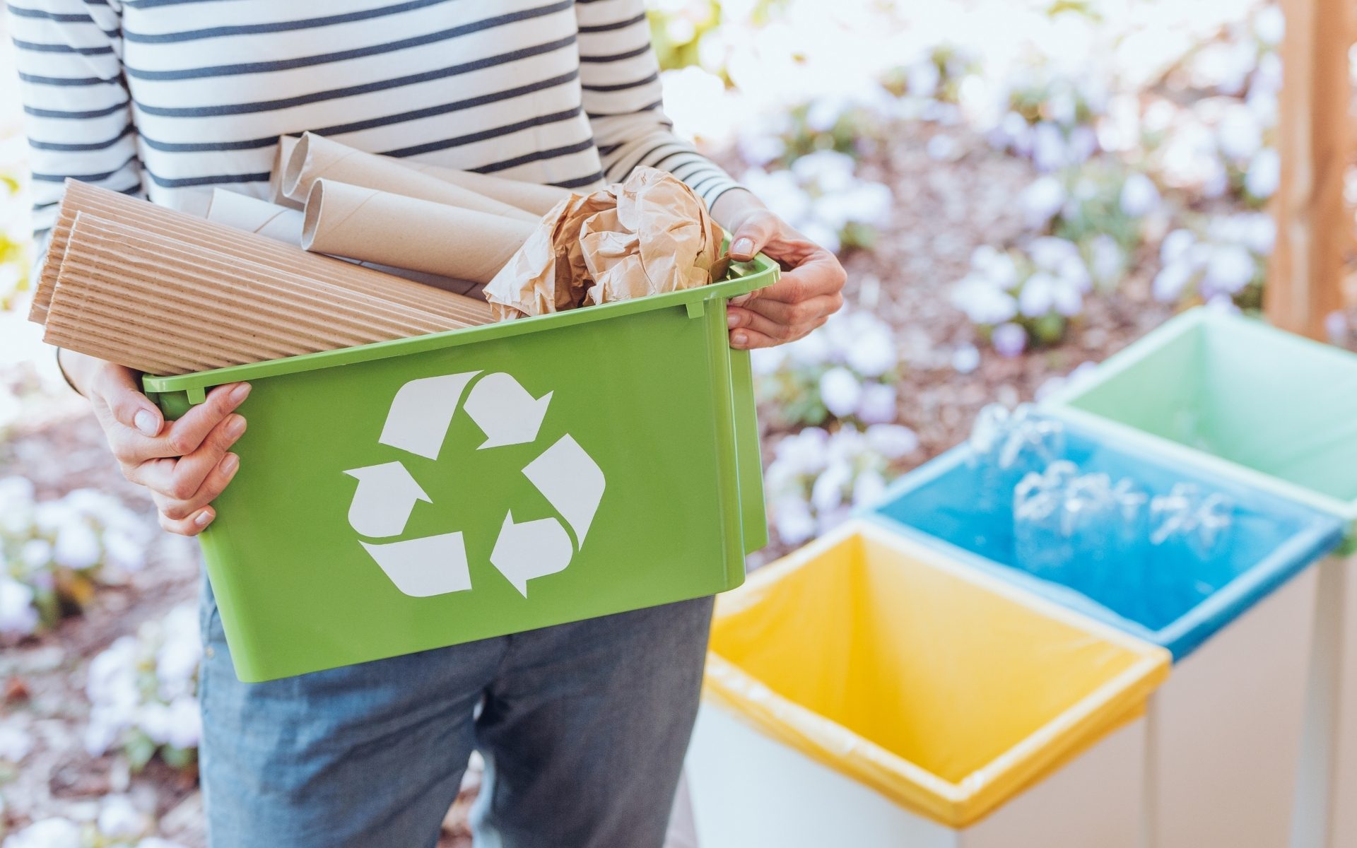 A woman recycling cardboard