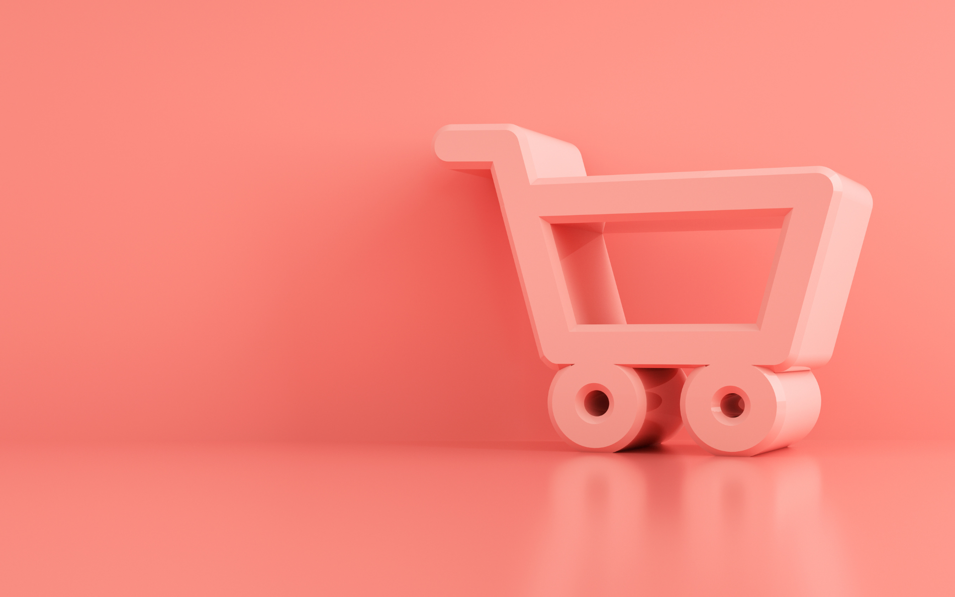 A toy shopping trolley against a pink background